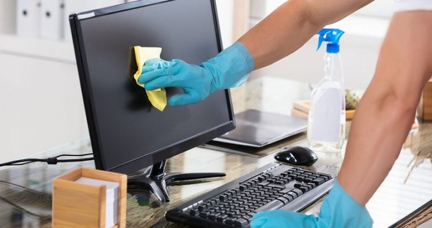 cleaning offices and desks to help prevent spread of coronavirus covid-19