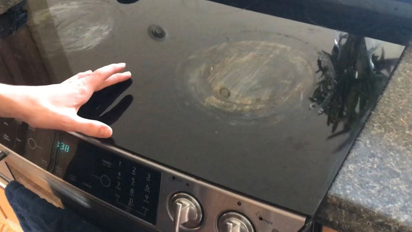 cleaning the top of an electric stove