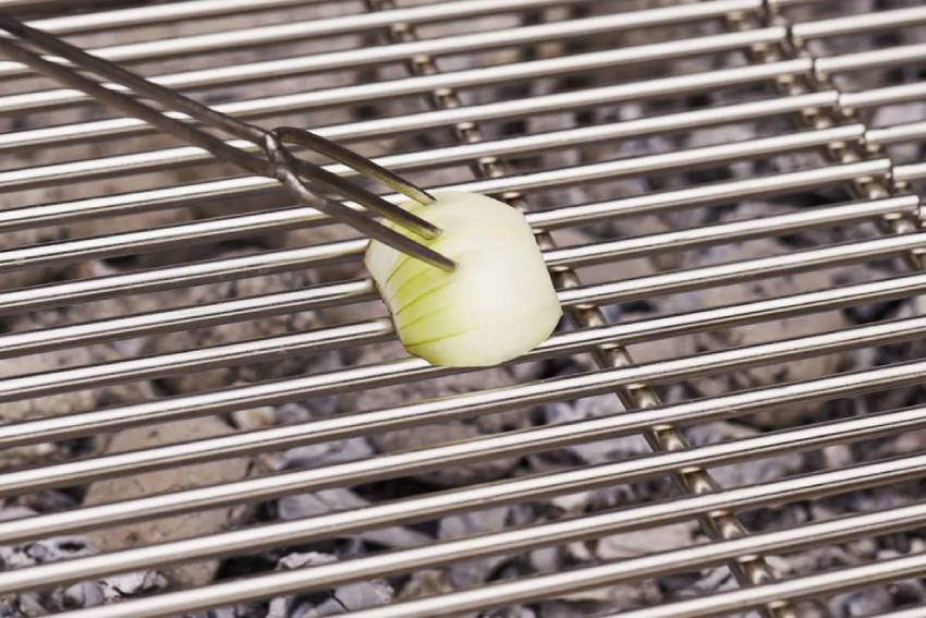 cleaning a grill with an onion