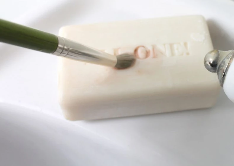 using soap to clean makeup brush